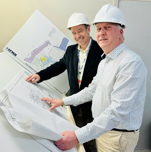 Board of Directors Chair Kevin Quade and SFMH COO Greg McLeod review the plans as construction begins.
